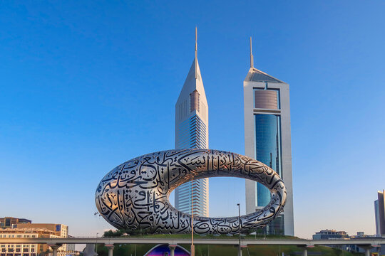 Dubai panoramic city skyline with modern skyscrapers and waterfront at daylight. Modern future Museum built according designed by architect Shaun Killa.