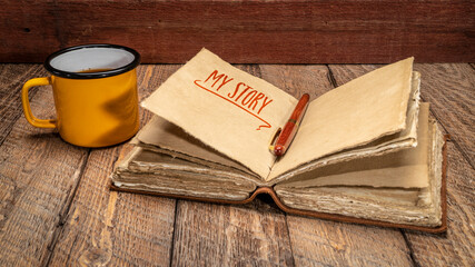 my story - handwriting in a retro  leather-bound journal with decked edge handmade paper pages and...