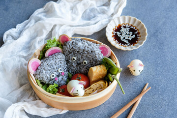 Homemade Japanese cuisine. Year Of The Rat Bento Box. Creative food craft, made with fresh ingredients and ideal for take away or picnic.