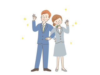 腕を組んでOKサインする男女のカップル