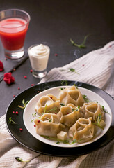 traditional Eastern dish manti or manty with beef in a dark