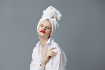 glamorous woman with a towel on his head in a white shirt isolated background