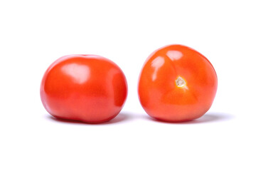 two ripe red tomatoes isolated on a white background