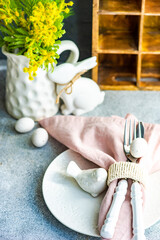 Easter table setting on concrete background