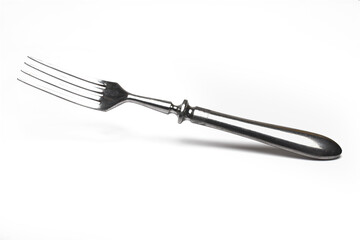 closeup silver antique old fork white background