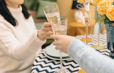 Close-up of glasses with champagne in female hands.
