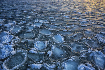freezing sea ice round pieces, ocean background winter climate coast