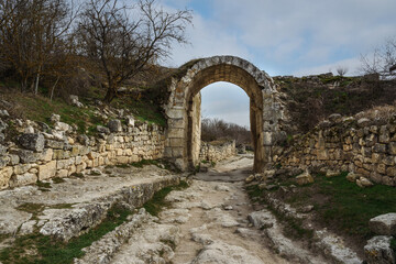 Fototapeta na wymiar The central defensive wall with Orta Kapu Gate in cave city Chufut-Kale in Bakhchysarai, Crimea