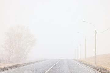 winter highway snowfall background fog poor visibility