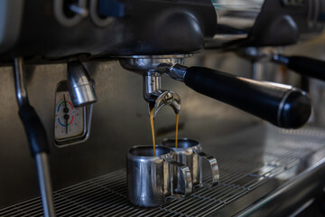 Close up of the process of making espresso in a professional coffee machine.