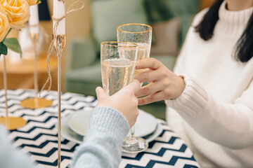 Close-up of glasses with champagne in female hands.
