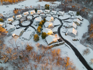 aerial view of residential community in winter after snow under sunlight