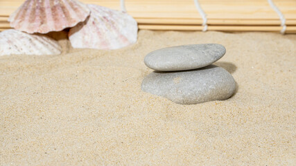 Fototapeta na wymiar gray stones on the sand, stones on the background of shells