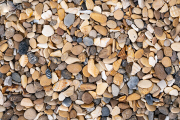 Smooth colored pebble texture background. Pebble sea beach close up, macro, background