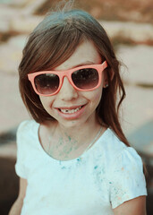 Cute child has fun with paints on Holi festival