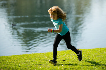 Child boy running outdoors. Child runner jogger running in the nature. Morning jogging. Active healthy kids lifestyle. Morning running with children.