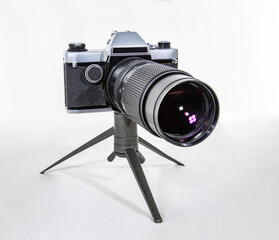 Vintage film camera made in the USSR of the 20th century with a large lens on a white background