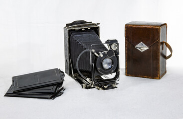 Vintage camera  made in the USSR in 1935 with cassettes and a brown leather case on a white...