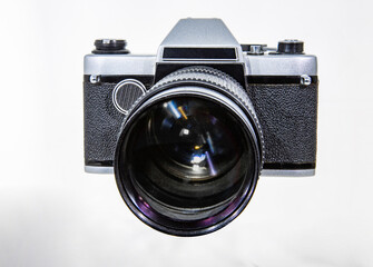 Vintage film camera made in the USSR of the 20th century with a large lens on a white background