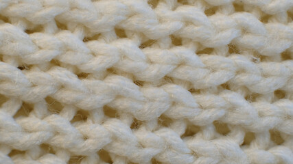 Fibers of knitted clothes with white threads. Knitted fabric threads macro. Stretching fibers. Textile abstract background.