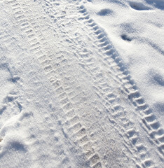 Trail from a car in the snow in winter.