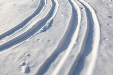 Trail from a car in the snow in winter.