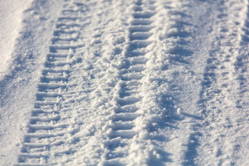 Fototapeta na wymiar Trail from a car in the snow in winter.
