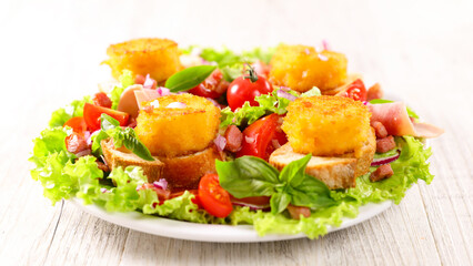 mixed vegetable salad with toast and goat cheese