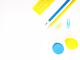 Yellow and blue stationery on white background top view. Design elements for banner, poster, card.