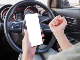 Girl clenching fists. Excellent. Mobile phone. On the car.