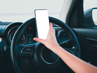 hand of a girl using a phone while driving a car.