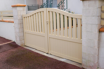 Fototapeta na wymiar steel classic beige sand metal gate fence of house street view