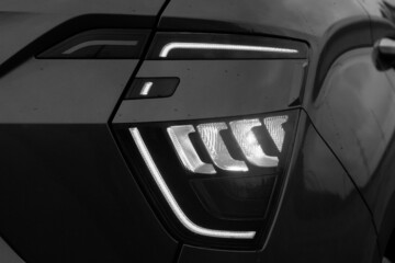 The appearance of a new car. Rear LED headlights with 3D effect. Black and white photo