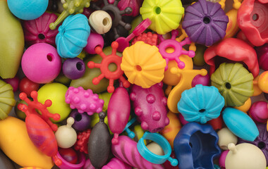 Children's plastic constructor. Background of bright multi-colored beads