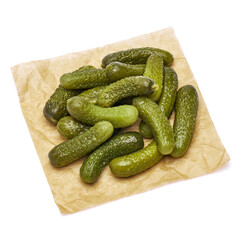 Tasty Whole green cornichons on parchment paper isolated on a white background