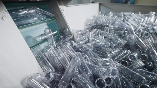 Automatic line for molding plastic, polyethylene bottles. Container with blanks.