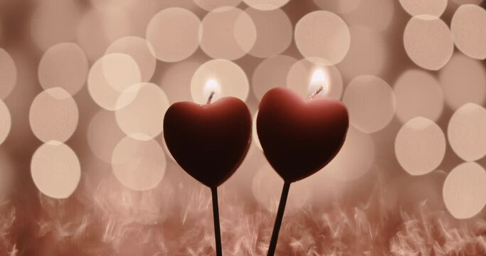 burning candles in the form of hearts on a background of beautiful bokeh. the concept of the passion of love and strong emotions of feelings and experiences. background for valentine's day