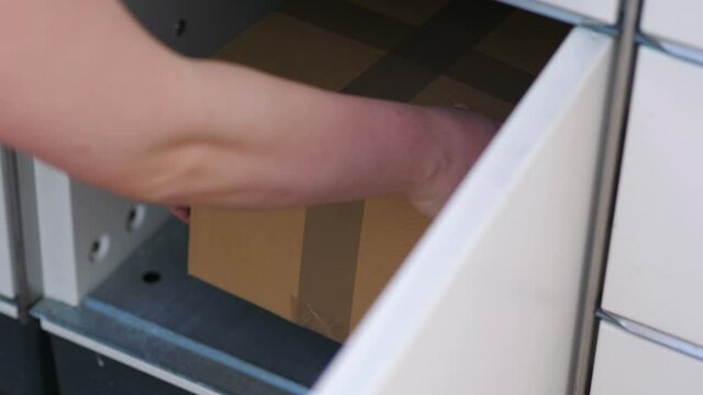 Putting a parcel to a parcel locker in 4k slow motion 60fps
