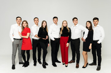 Obraz premium group of young people on a white background. brothers and sisters. company of friends in formal wear on a white background