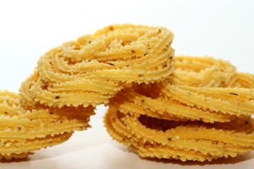 Murukku is a popular South Indian fried snack made with rice flour, lentil flours, spices and seasonings