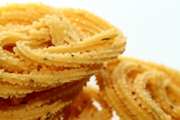 Murukku is a popular South Indian fried snack made with rice flour, lentil flours, spices and seasonings