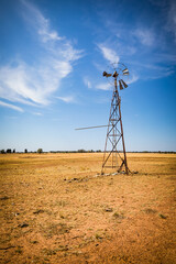 A broken down old water pump windmill on a rural farm in Outback Australia.