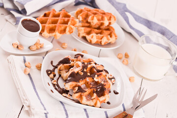 Waffles with chocolate cream and hazelnuts.