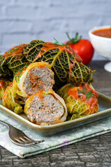 Gołabki - classic Polish dish of cabbage rolls stuffed with pork and rice in tomato sauce