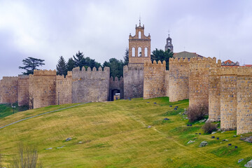 Walled city with high stone towers in the medieval city of Avila, Spain.