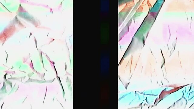 Glitch texture. Digital noise overlay. Transmission defect. Orange blue color flicker fuzzy artifacts on dark black white creased background for transition.