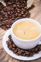 Fototapeta premium Coffee in white cup and roasted dark coffee beans