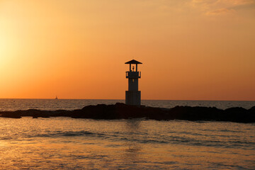 Landscape nature sunset and red  twilight sky with Silhouette  lighthouse on the rock at Nang Thong Beach at Khao Lak Phang Nga Thailand - Seascape chill vibe on the beach - beautiful sky  