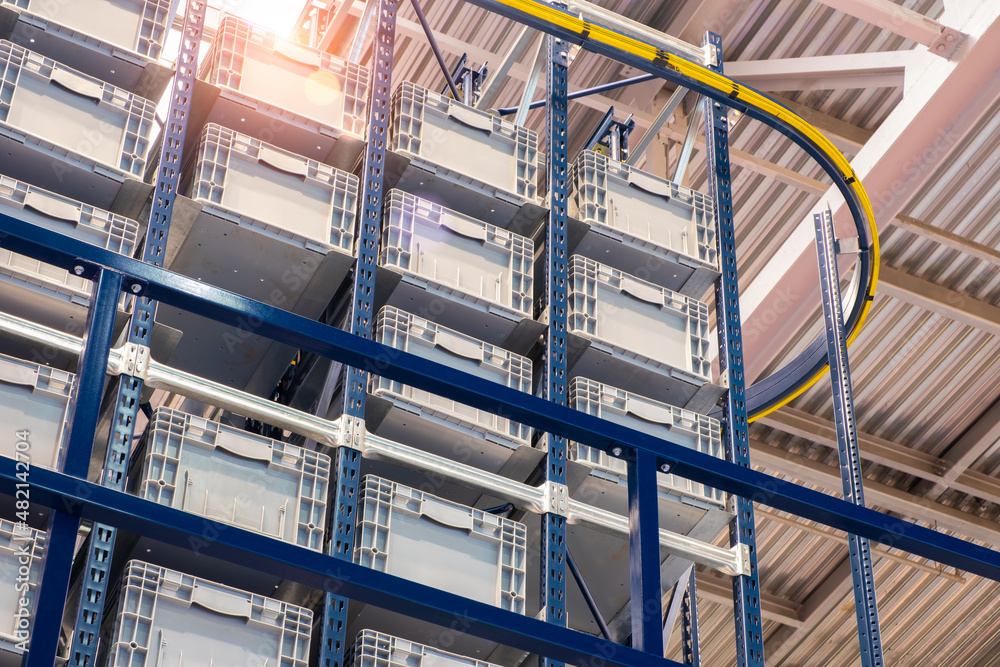 Poster huge distribution warehouse with high shelves and loaders. bottom view.