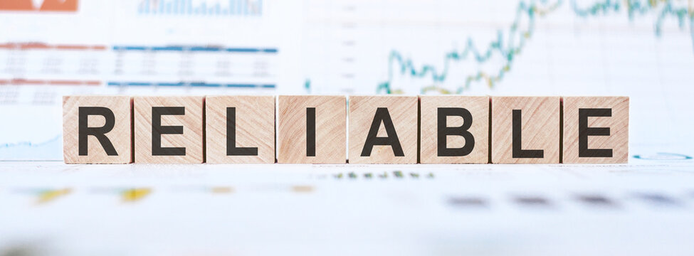 RELIABLE word made with wooden blocks on a white background